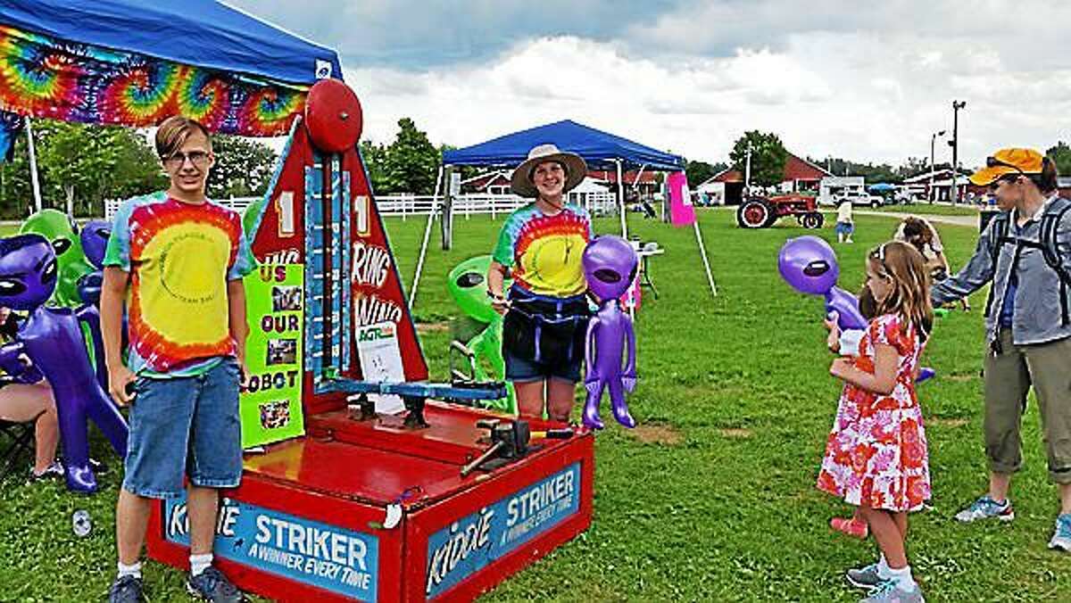 4-H Club members Sean Kelchner and Carol Pelizzari sold customized-art alien balloons as a fundraiser for her robotics club on Saturday afternoon at the 83rd Litchfield County 4-H Fair at the Goshen Fairgrounds at 116 Old Middle St. in Goshen.