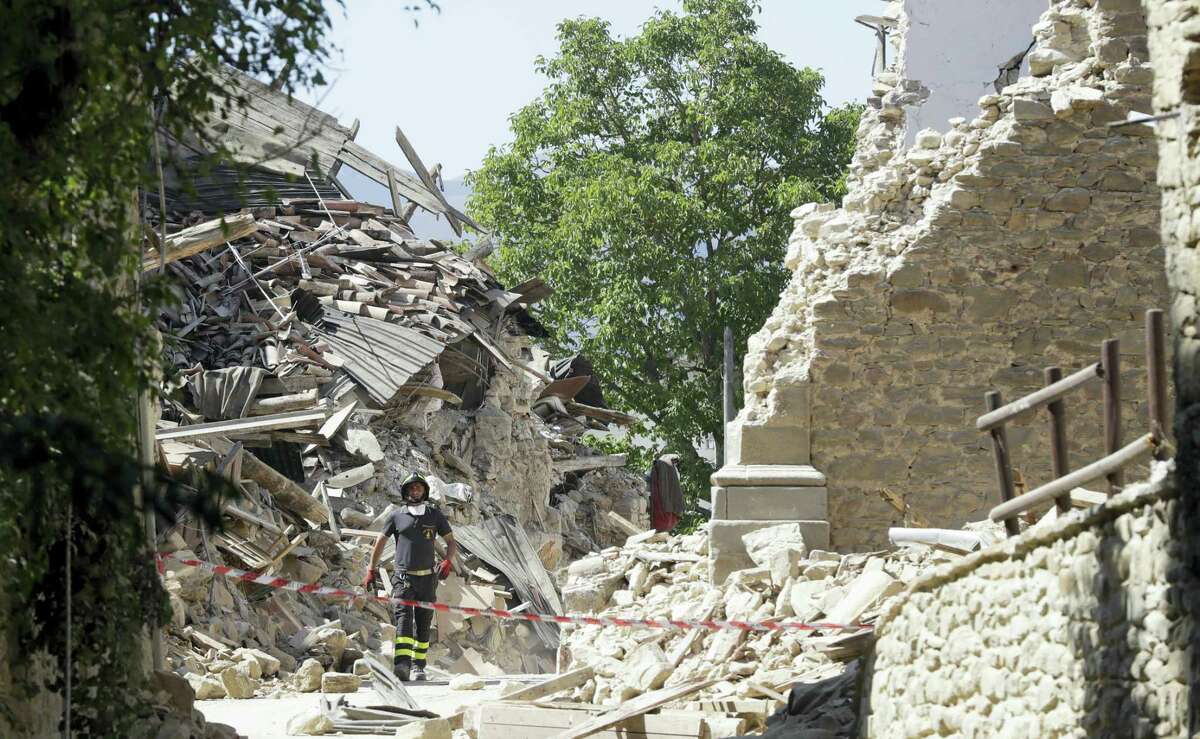 A firefighter stands by a cordoned off area in Amatrice, central Italy, Thursday, Aug. 25, 2016, where a 6.1 earthquake struck just after 3:30 a.m., Wednesday. Rescue crews raced against time Thursday looking for survivors from the earthquake that leveled three towns in central Italy and Italy once again anguished over how to secure its towns and cities, new and old, built on seismic lands.