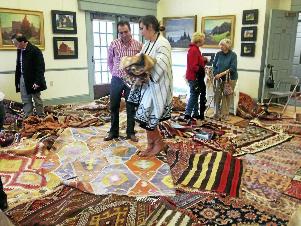 Contributed photo The Gunn Historical Museum, the Roxbury Museum & Hodge Memorial Library, and the Minor Memorial Library will hold the annual collaborative Turkish-Rug-Sale Fundraiser, on Saturday, Nov. 5 from 12-4 p.m. Above, visitors choose from a selection of rugs during last year's sale.