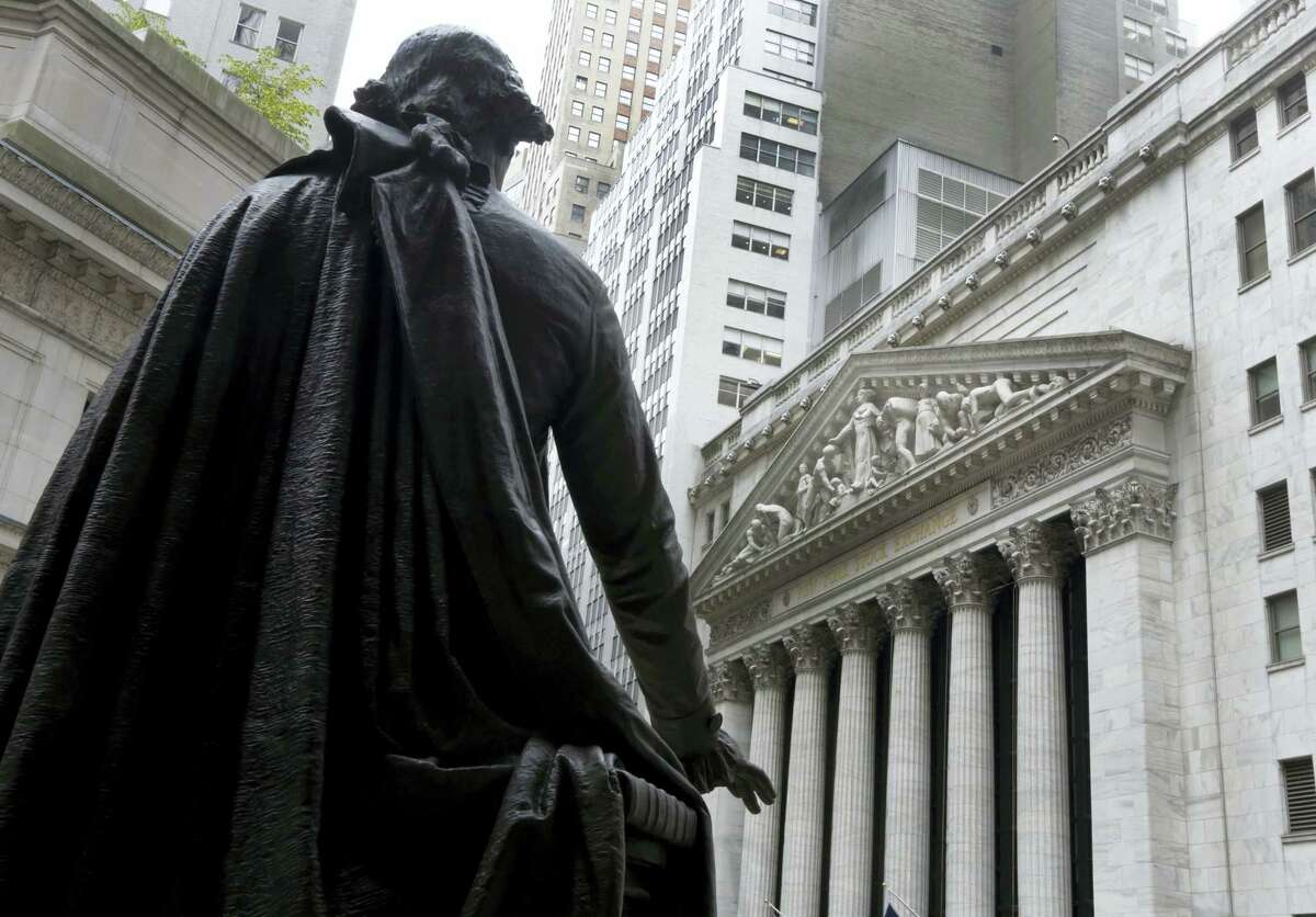 The statue of George Washington on the steps of Federal Hall faces the facade of the New York Stock Exchange.