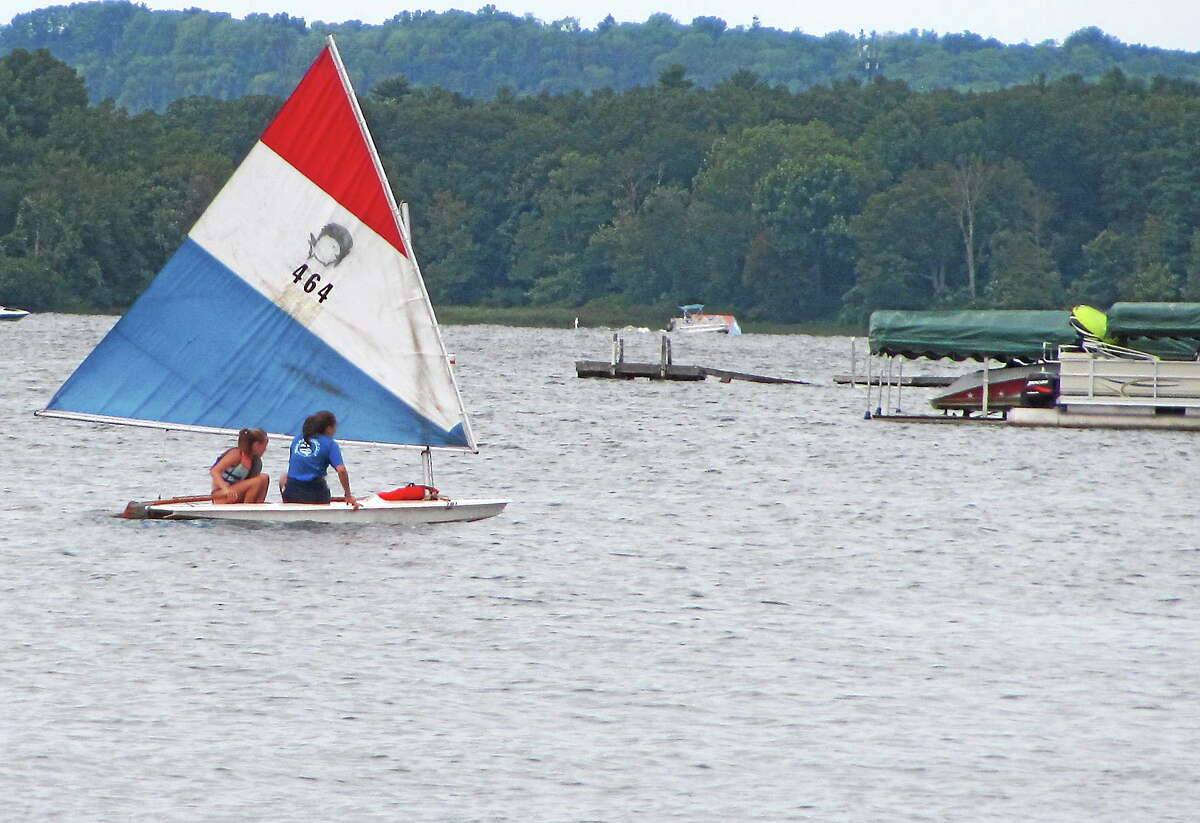 File photo - The Register Citizen Sailors take a small boat out on Bantam Lake during the inaugural Bantam Lake Day celebration in Morris in 2014. In spite of health concerns, the annual lake day will be held Saturday, but no swimming will be allowed.