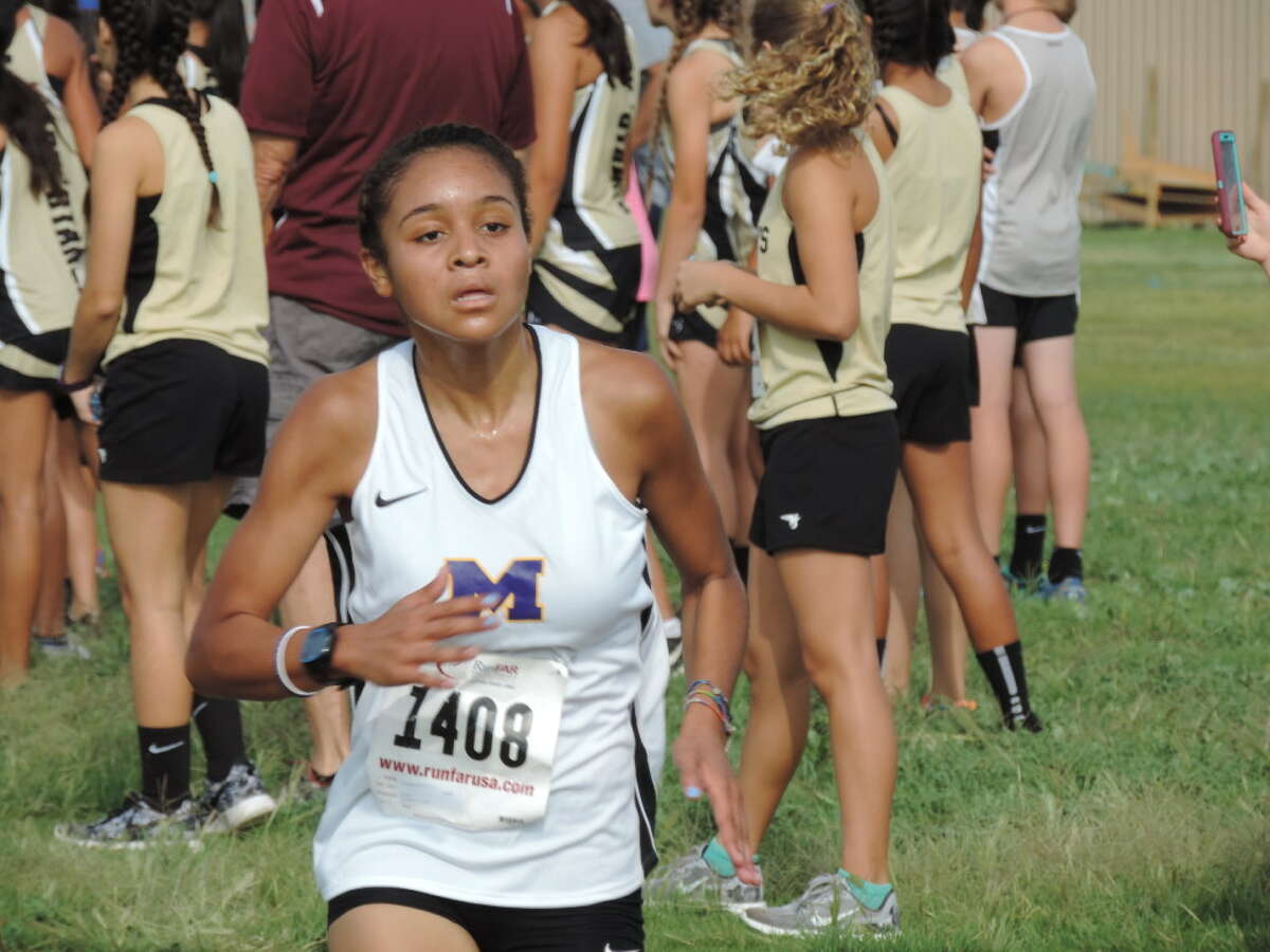 Midland High junior Jenia Mitchell approaches the finish-line during the Tall City Cross-Country Invitational on Saturday at Rock the Desert Festival Field. Mitchell finished second with a time of 20 minutes, 22.04 seconds. Christopher Hadorn/Reporter-Telegram