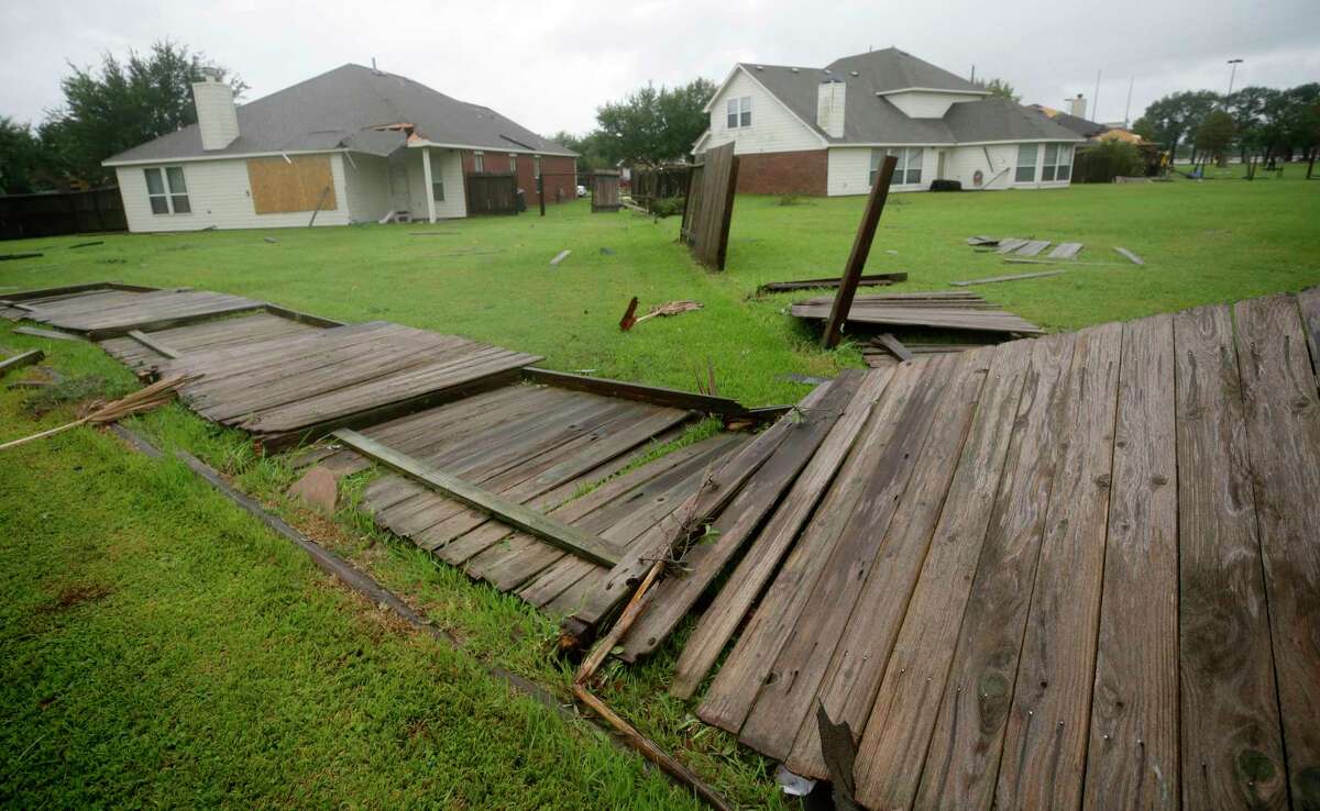 Downed fences and damage to homes are shown after a tornado hit in the Lone Oak subdivision Saturday, Aug. 26, 2017, in Cypress. Several tornadoes from Hurricane Harvey have been reported in the area.