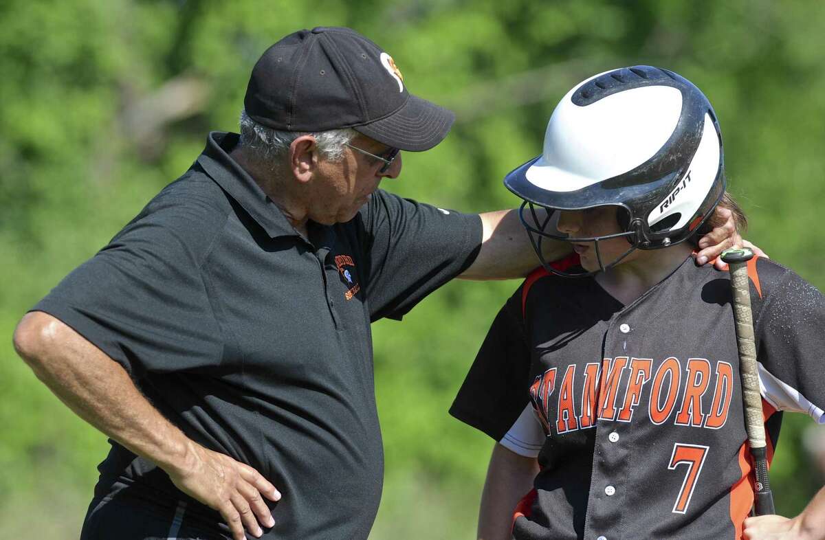Stamford head coach Tony Esposito talks with Allie Buzzeo (27) at first base during the State Class LL softball game between Stamford and Danbury high schools, on Tuesday afternoon, May 31, 2016, at Danbury High School, Danbury, Conn.