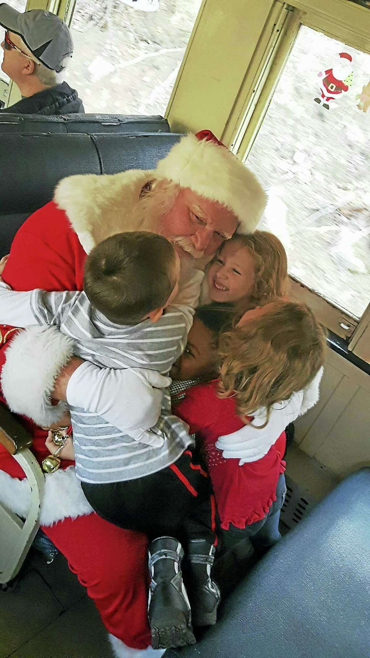 Photos by Heather StamppChildren hug Santa Claus during their train ride.