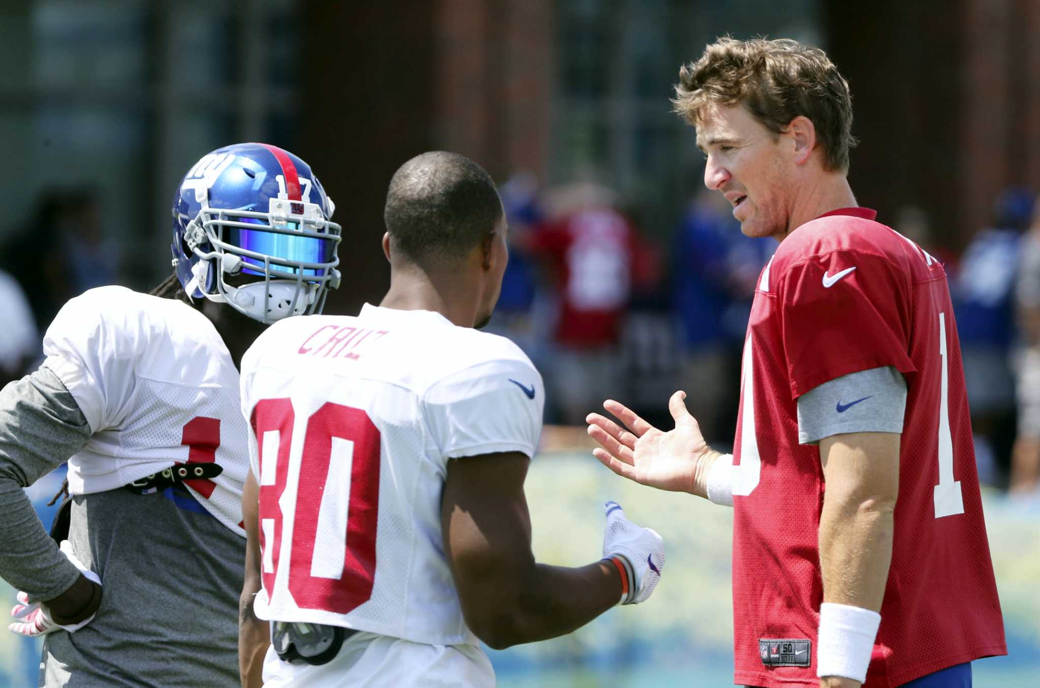 New York Giants starting quarterback Eli Manning rolls out to the