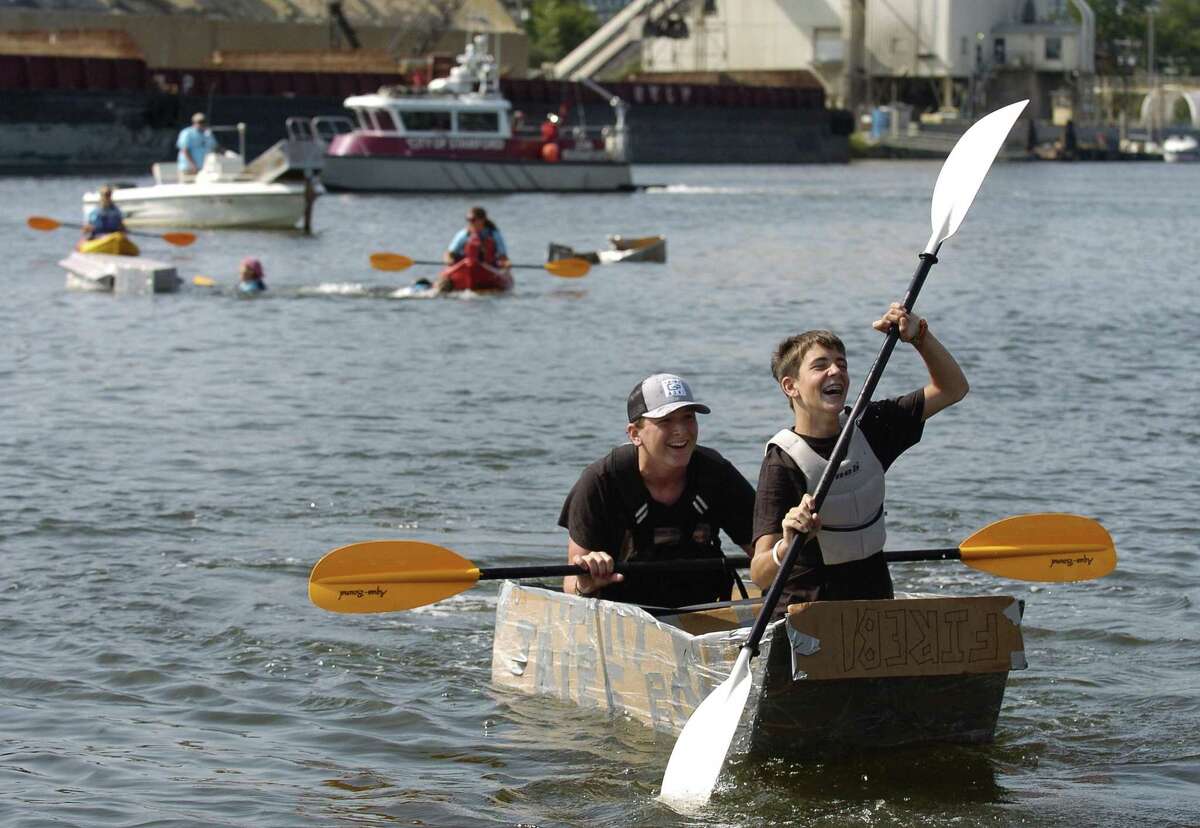 Griffen Gigliotti and friend Max Touzot, both of Stamford, celebrate winning the Soundwaters Harborfest 17 Cardboard Kayak Race for team Tribe Boys in Stamford, Connecticut on Saturday, August 25, 2017.