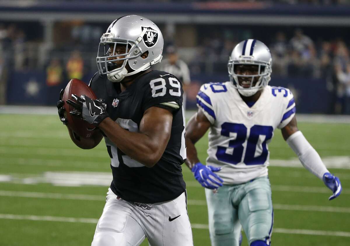 Oakland Raiders wide receiver Amari Cooper catches a pass in front of Dallas Cowboys cornerback Anthony Brown (30) and head sot the end zone for a touchdown in the first half of a preseason NFL football game, Saturday, Aug. 26, 2017, in Arlington, Texas. (AP Photo/Michael Ainsworth)
