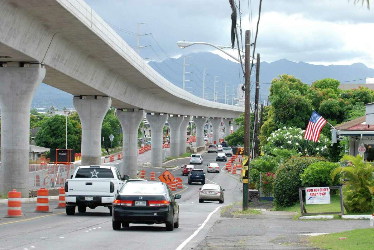 In this May 18, 2017 photo, a rail line under construction winds through the Honolulu suburb of Aiea, Hawaii. Honolulu's planned $9.5 billion rail transit project is one of the most expensive per capita in the nation. But it's facing a multi-billion dollar budget shortfall, and the future of the project is in jeopardy. Hawaii lawmakers are meeting this week to decide how to cover a budget shortfall as high as $3 billion. (AP Photo/Cathy Bussewitz) ORG XMIT: FX402