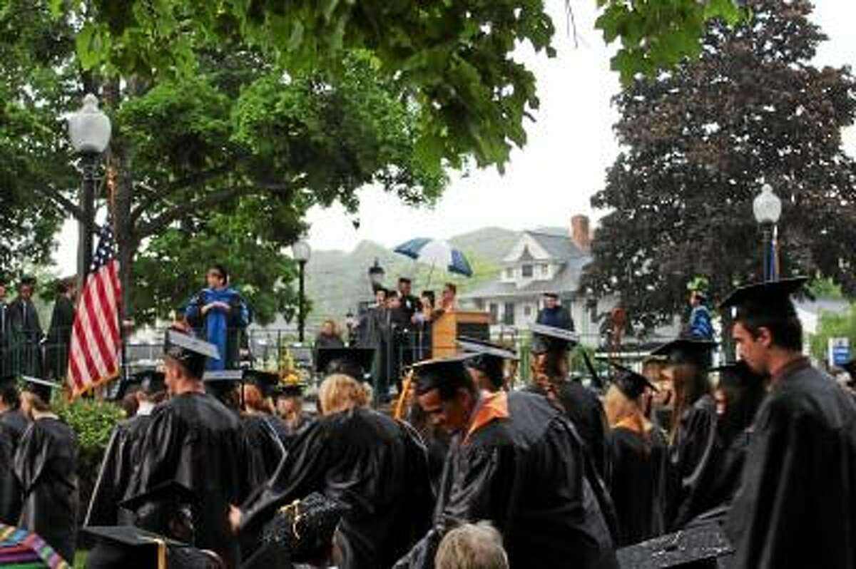 JASON SIEDZIK/Register Citizen - The 176 members of the Class of 2013 did not let a surprise storm dampen their spirits as they received their certificates and degrees Thursday evening.