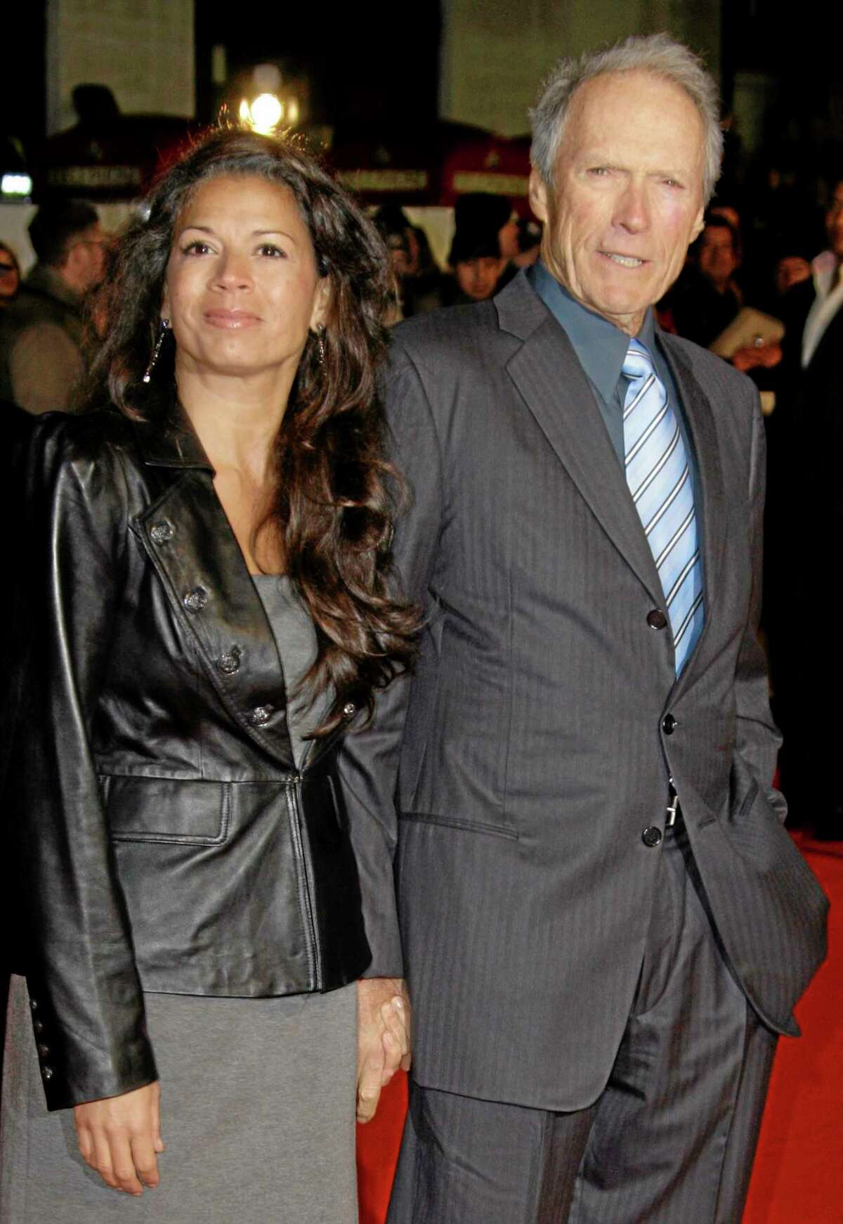 FILE - U.S Director Clint Eastwood, right, arrives with his wife, Dina on the red carpet for the UK premiere of Invictus at London's Leicester Square, in this Jan. 31, 2010 file photo. Eastwood's second wife has filed for legal separation from the actor and director. Dina Eastwood's petition filed in Monterey County Superior Court on Monday Sept. 9, 2013 seeks spousal support and physical custody of the couple's 16-year-old daughter, Morgan.(AP Photo/Joel Ryan, File)