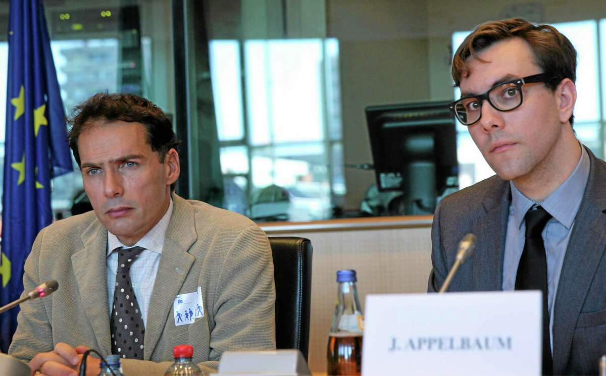 Jacques Follorou, journalist for French newspaper Le Monde, left, and U.S. investigative journalist, software developer and computer security researcher with the Tor Project, Jacob Appelbaum, attend a hearing at the European Parliament building in Brussels, Sept. 5.