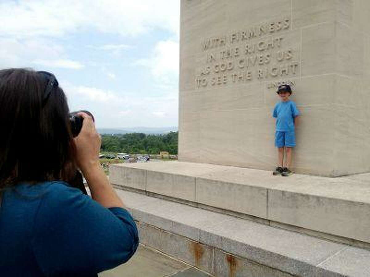 Ellen Stewart, of Blackwood, N.J., photographs her son, Johnny, 8, at the Eternal Light Peace Memorial on Friday. Stewart and her husband, John, brought Johnny to Gettysburg for his birthday gift.