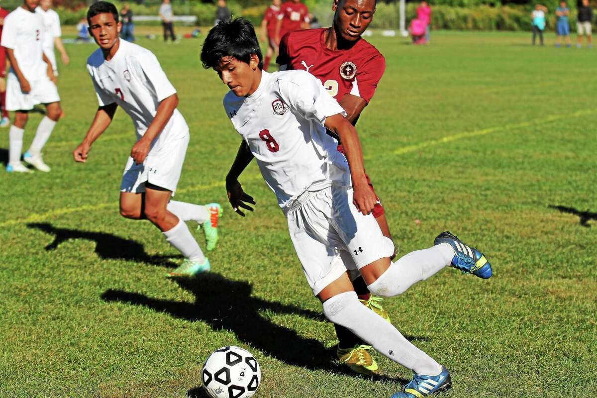Torrington’s Kevin Vaca dribbles the ball as Sacred Heart defends on Monday.