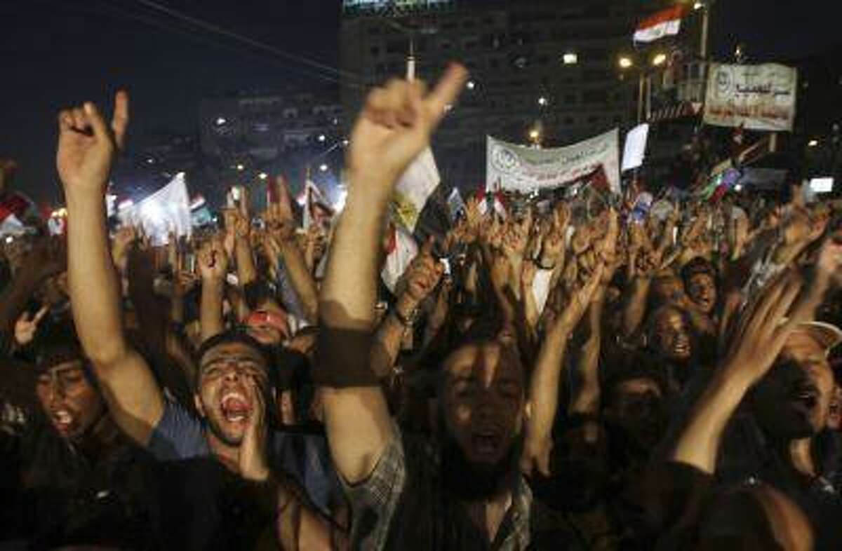 Islamists, members of the brotherhood, and supporters of Egyptian President Mohamed Mursi shout slogans with brotherhood's flag during a protest around the Raba El-Adwyia mosque square in the suburb of Nasr City, Cairo, June 28, 2013.