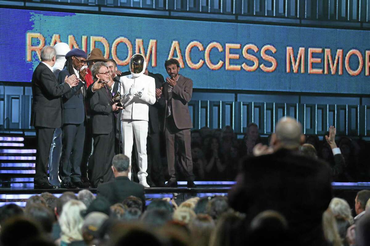 Paul Williams, center, accepts the award for album of the year for Daft Punk's "Random Access Memories" at the 56th annual Grammy Awards at Staples Center on Sunday, Jan. 26, 2014, in Los Angeles. (Photo by Matt Sayles/Invision/AP)