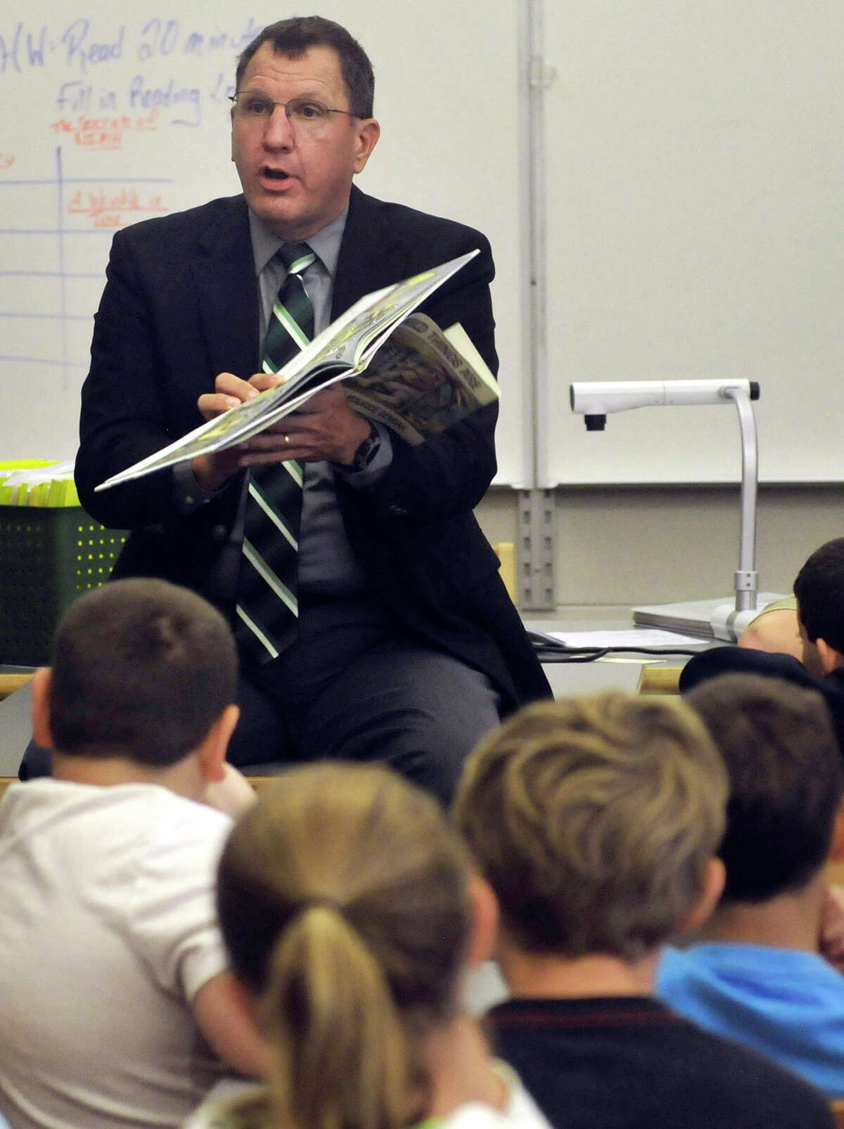 Tuscarora School District Superintendent Dr. Charles Prijatelj reads during International Literacy Day Monday, Sept. 8, 2014 at James Buchanan Middle School, in Mercersburg, Pa. (AP Photo/Public Opinion, Markell DeLoatch)
