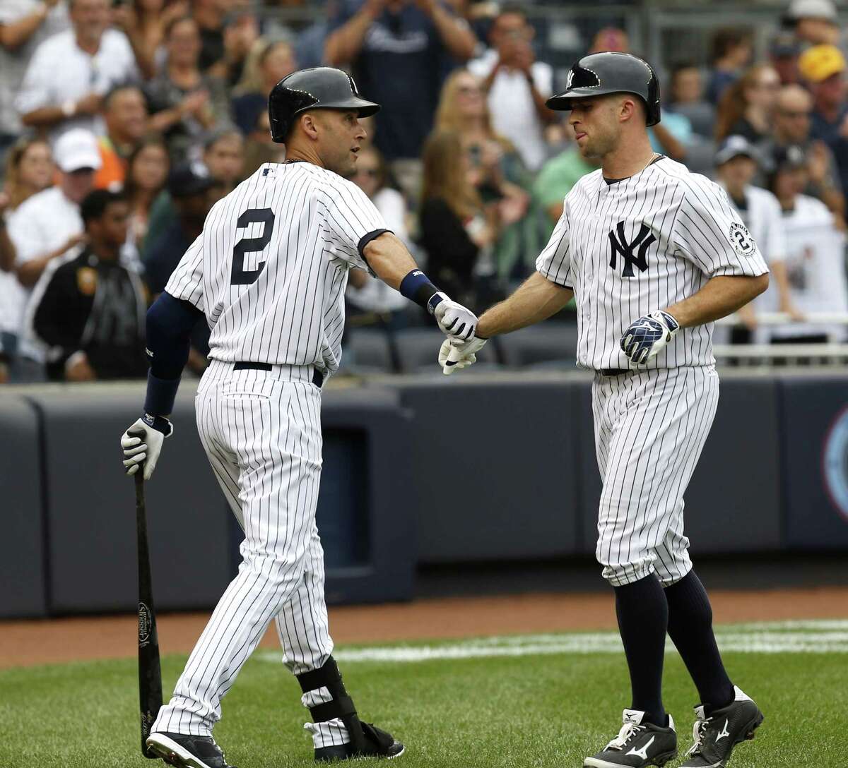 Brett Gardner, right, is greeted by Derek Jeter after he hit a solo home run during the fifth inning Sunday.