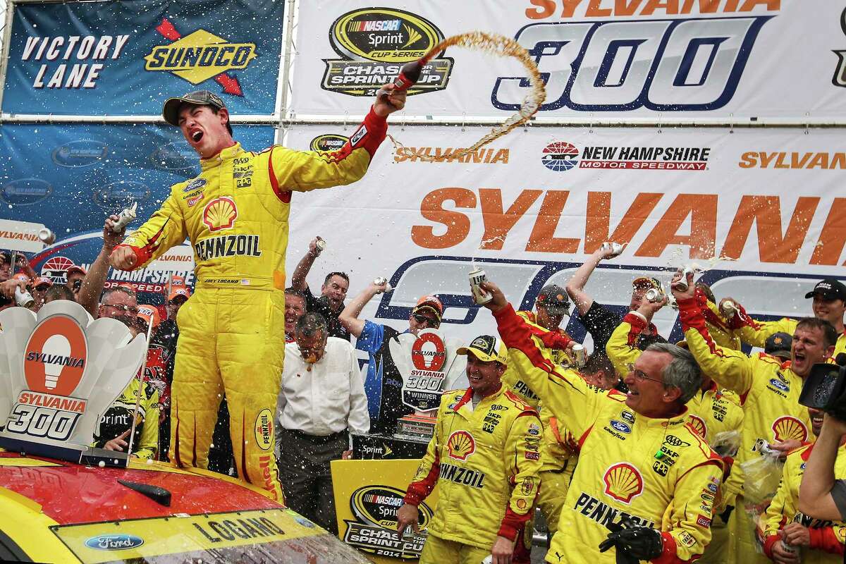 Joey Logano celebrates in victory lane after winning at New Hampshire Motor Speedway on Sunday.