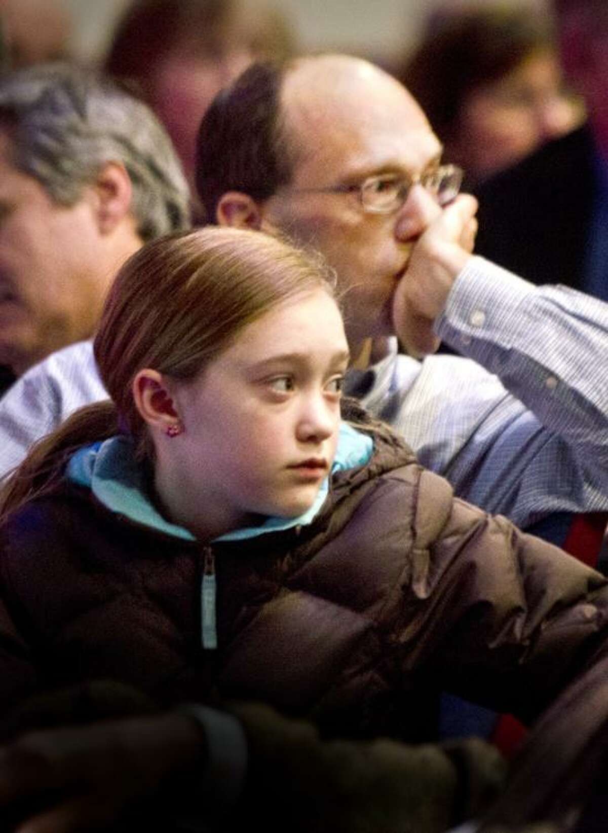Waterbury--Monte Frank, and his daughter Sarah Frank,11, of Sandy Hook listen to people speaking from the crowd gathered for a Town Hall meeting on guns. The meeting, held by Congresswoman Elizabeth Esty, took place at Rotella Interdistrict Magnet School. Sarah was taught by slain Sandy Hook teacher, Victoria Soto. Melanie Stengel/Register
