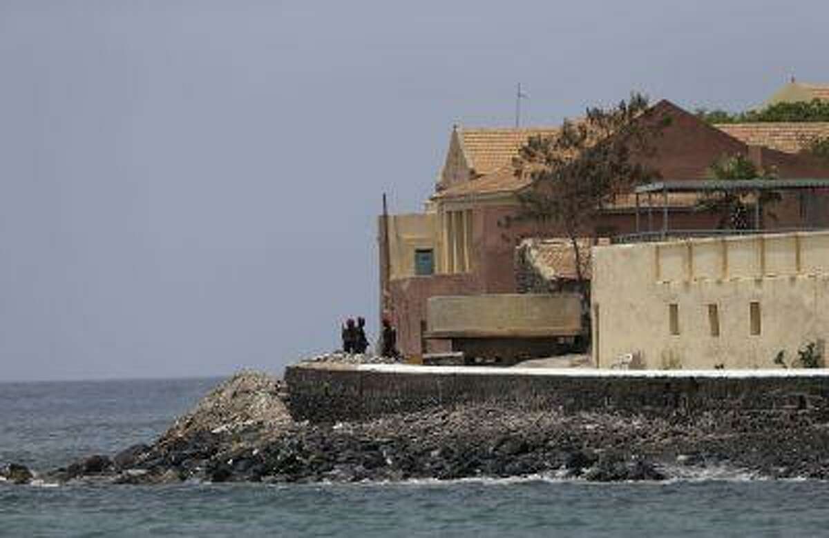 Senegalese soldiers stand guard near the slave house on Goree Island, ahead of a visit by U.S. President Barack Obama, in Dakar, Senegal, Thursday, June 27, 2013. Obama is calling his visit to a Senegalese island from which Africans were said to have been shipped across the Atlantic Ocean into slavery, a 'very powerful moment.' President Obama was in Dakar Thursday as part of a weeklong trip to Africa, a three-country visit aimed at overcoming disappointment on the continent over the first black U.S. president's lack of personal engagement during his first term.(AP Photo/Rebecca Blackwell)