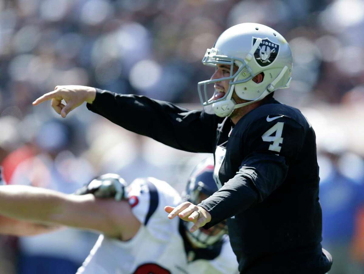 Raiders quarterback Derek Carr throws under pressure in the second quarter of last Sunday’s game against the Houston Texans in Oakland, Calif.