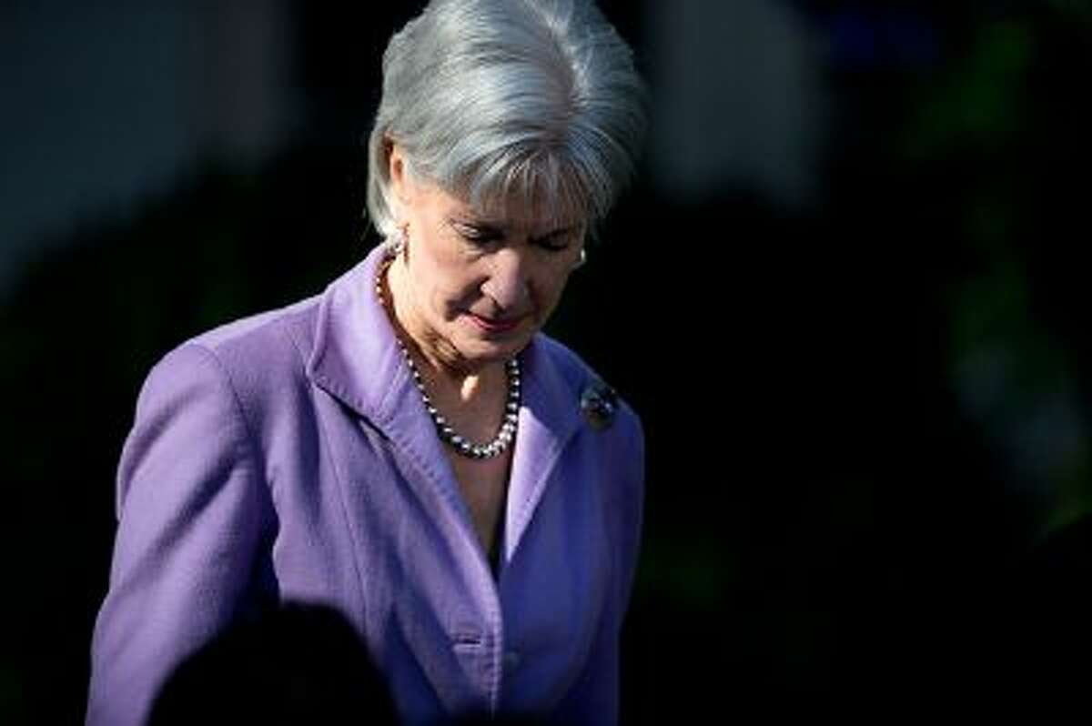Health and Human Services Secretary Kathleen Sebelius arrives in the Rose Garden of the White House in Washington for and event with President Barack Obama on the initial rollout of the health care overhaul. As the public face of President Barack Obama's signature health care program, Sebelius has become the target for attacks over its botched rollout. Republicans want her to resign and even some Democrats - while not mentioning her name - say someone needs to be fired.