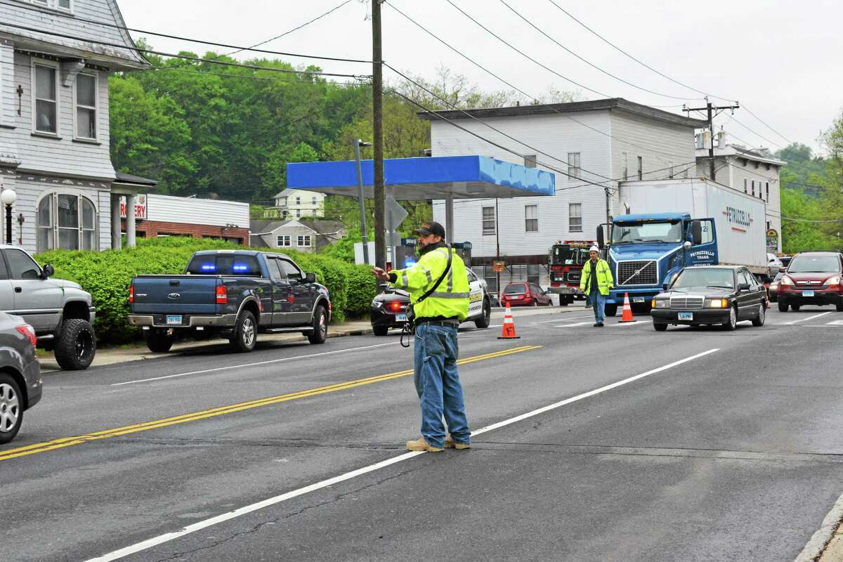 Volunteer firefighters directed traffic around the scene of an accident on Main Street in Winsted Thursday afternoon.