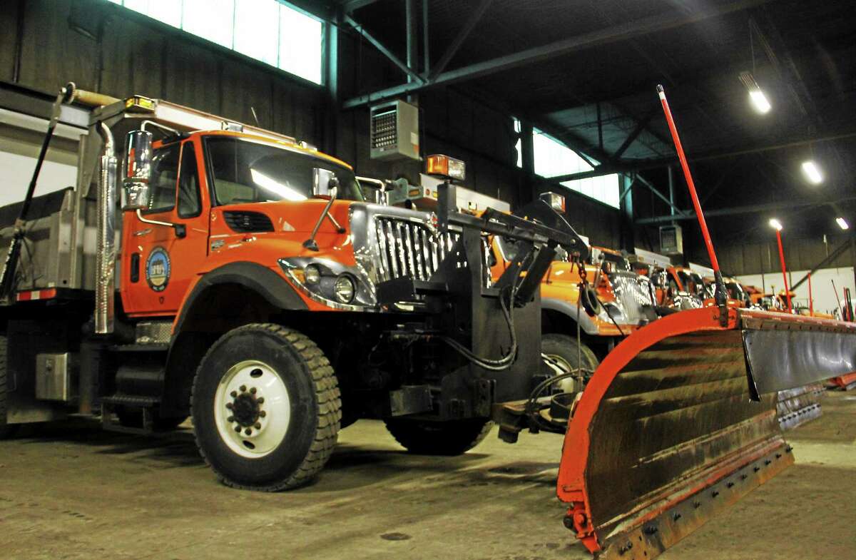 A row of snow plow trucks used by the City of Torrington inside the Public Works Department Depot as seen on Friday, Dec. 13, 2013.