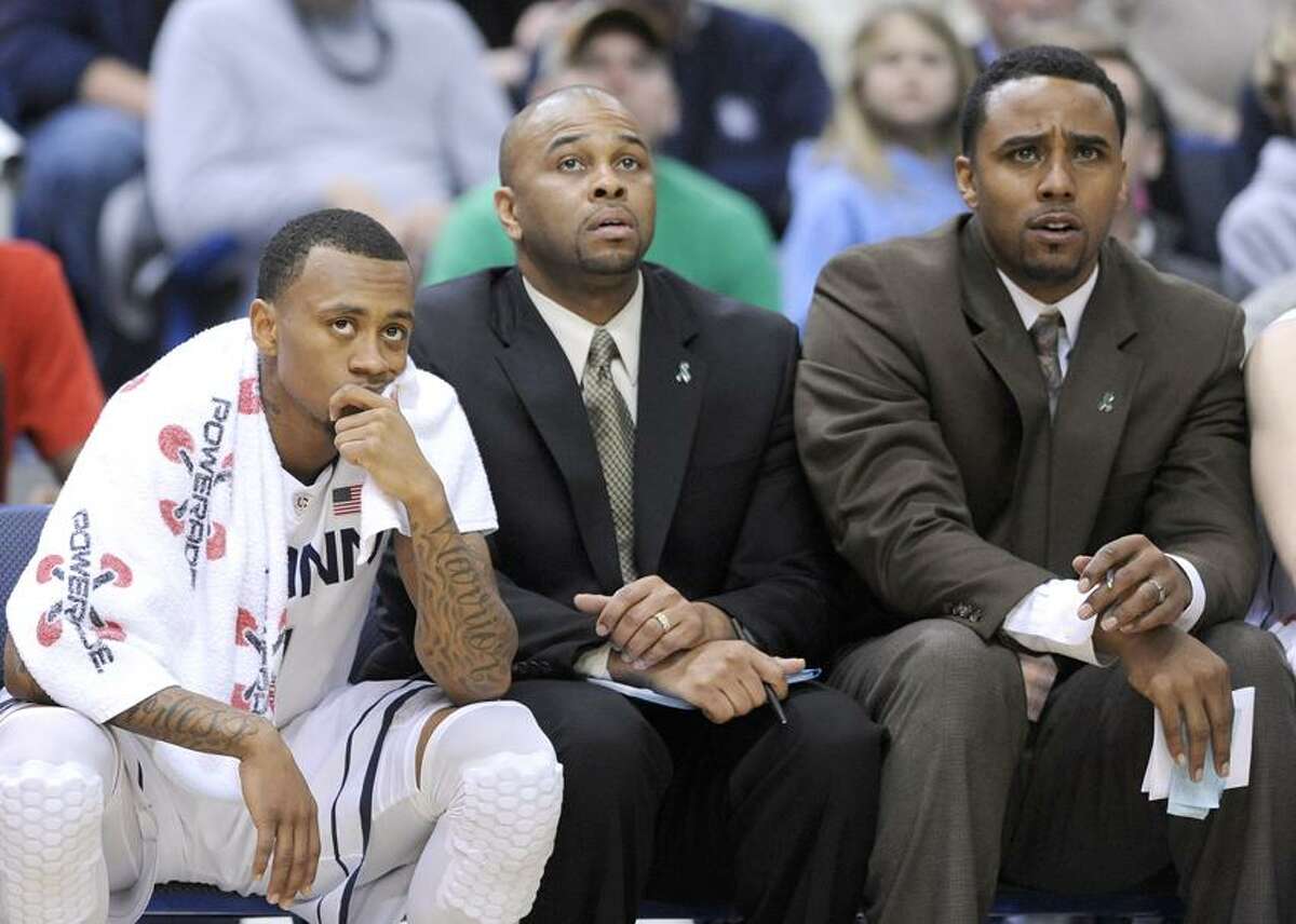 Connecticut's Ryan Boatright, and coaches Ricky Moore, and Kevin Freeman, left to right, react late in their team's 70-61 loss to Villanova in an NCAA college basketball game in Hartford, Conn., Saturday, Feb. 16, 2013. (AP Photo/Fred Beckham)