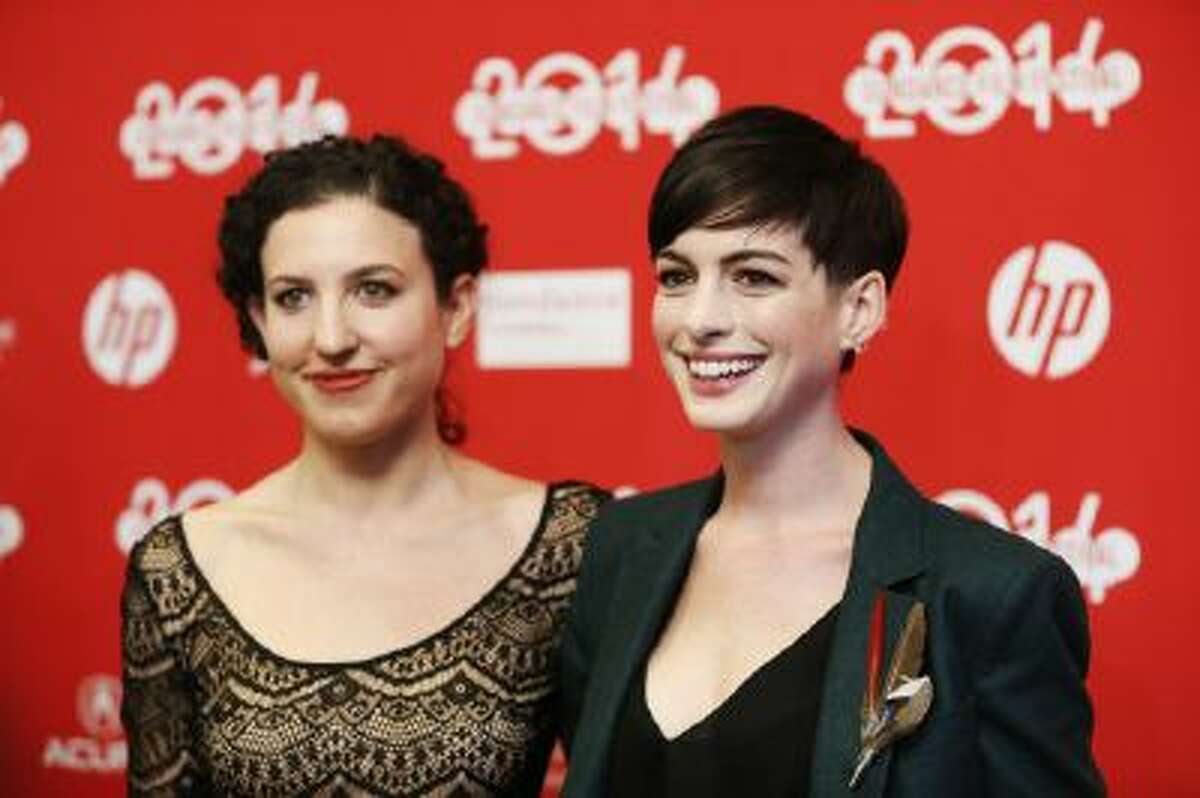 In this Mon., Jan. 20, 2014 file photo, writer and director Kate Barker-Froyland, left, and cast member Anne Hathaway, pose together at the premiere of the film "Song One" during the 2014 Sundance Film Festival, in Park City, Utah.