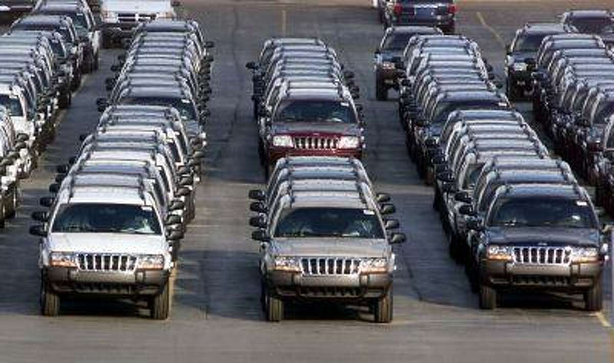 FILE - In this Feb. 2, 2001 file photo, rows of 2001 Jeep Grand Cherokees are lined up outside the Jefferson North Assembly Plant in Detroit. After an agreement between Chrysler and the U.S. government to remove about 1.2 million Jeep Grand Cherokees, model years 1999 to 2004, from a recall in June 2013, some owners are confused about the safety of their vehicles. Chrysler argued that those Jeeps have a different design than the ones it agreed to recall and are as safe as comparable models from other automakers. (AP Photo/Carlos Osorio, File)