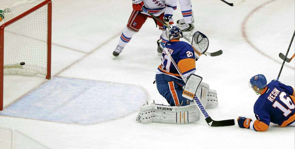 New York Islanders goalie Evgeni Nabokov watches a puck shot by the New York Rangers’ Benoit Pouliot gets past him for a goal during the third period Tuesday in Uniondale, N.Y. The Rangers won the game 3-2.