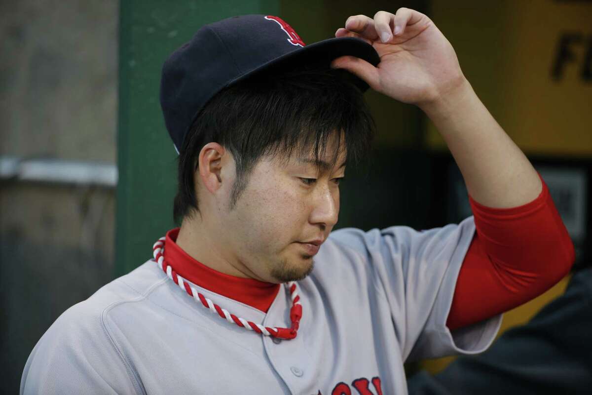 Red Sox reliever Junichi Tazawa stands in the dugout before Thursday’s game.