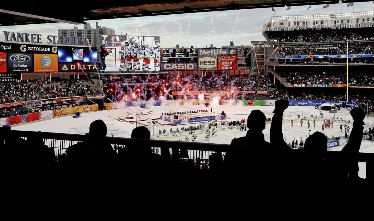 Rangers fans cheer during a pyrotechnics display after Saturday’s game against the Devils at Yankee Stadium. The Rangers won 7-3.