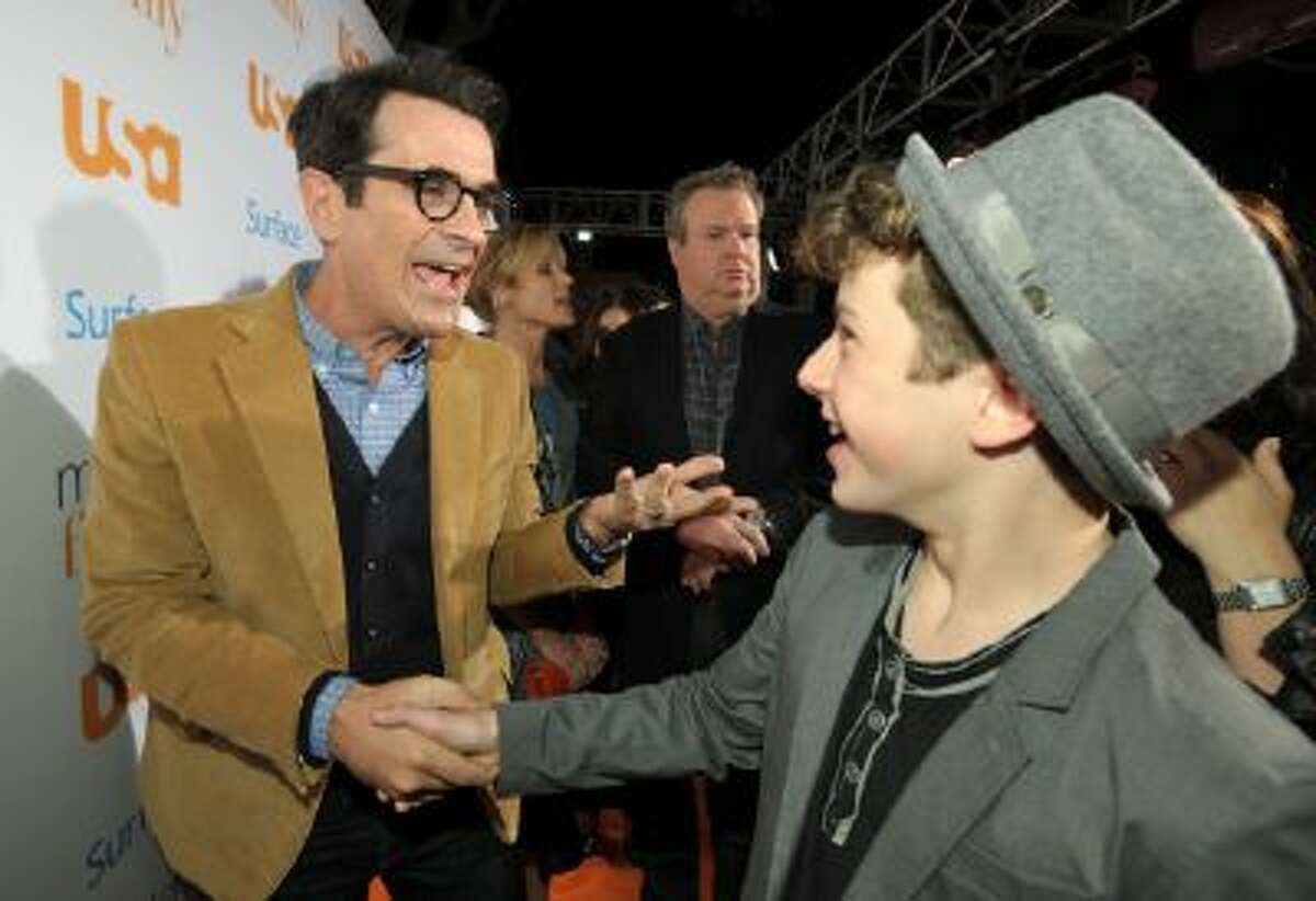 Cast members Ty Burrell, left, and Nolan Gould shake hands at USA Network's "Modern Family" Fan Appreciation Day at the Westwood Village Theatre on Monday, Oct. 28, 2013 in Los Angeles.