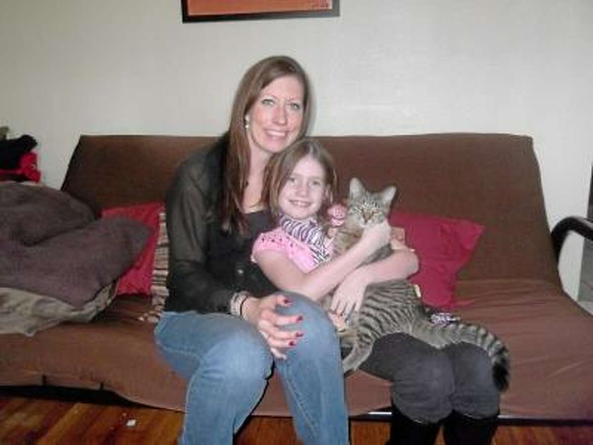 Mia Pickert, her mother Jacki Pickert and their cat Gizmo. Mia will be turning 9 on Feb. 23. Instead of asking for presents she requested people donate clothing items for people in need. NIKKI TRELEAVEN/The Register Citizen