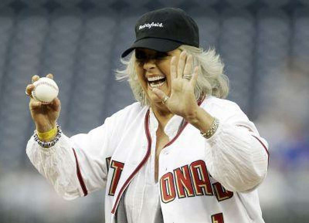 Food Network personality Paula Deen laughs before throwing out the first pitch prior to the Washington Nationals versus New York Mets MLB baseball game in Washington in this file photo taken May 19, 2010. REUTERS/Gary Cameron/Files
