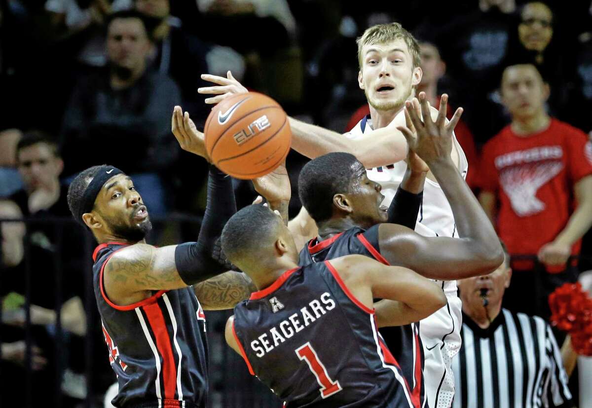 UConn guard Niels Giffey is swarmed by Rutgers defenders during the second half of Saturday’s game against Rutgers.