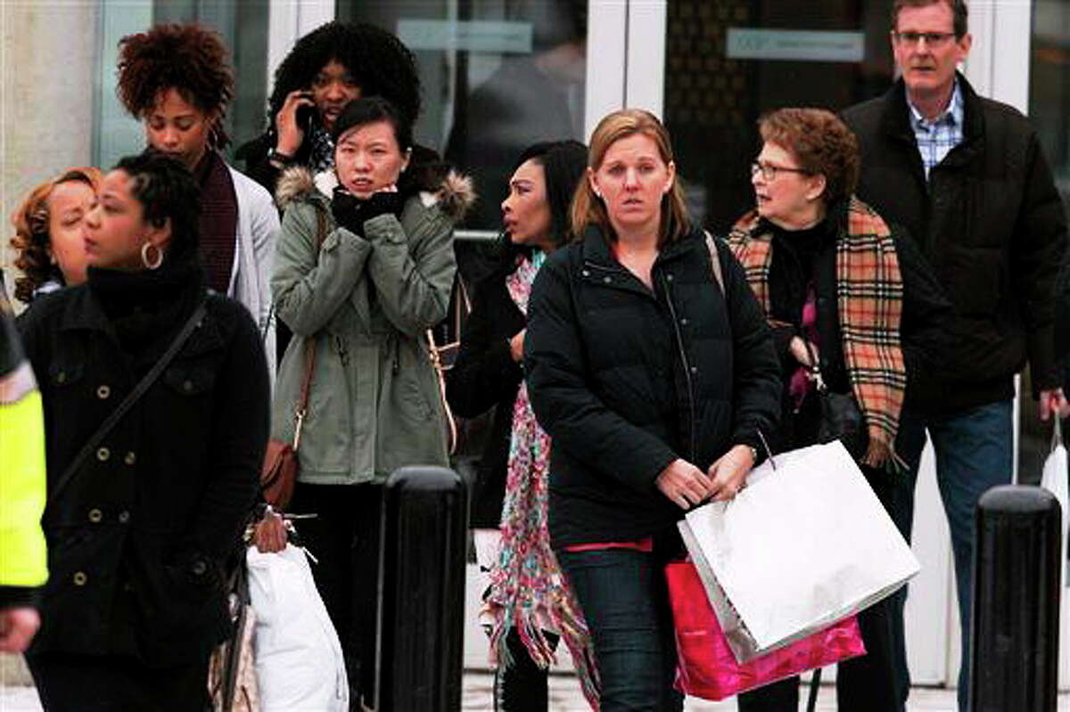 Shoppers are evacuated by police after a shooting at The Mall in Columbia on Saturday, Jan. 25, 2014, in Columbia, Md. Police say three people died in a shooting at the mall in suburban Baltimore, including the presumed gunman. (AP Photo/ Evan Vucci)