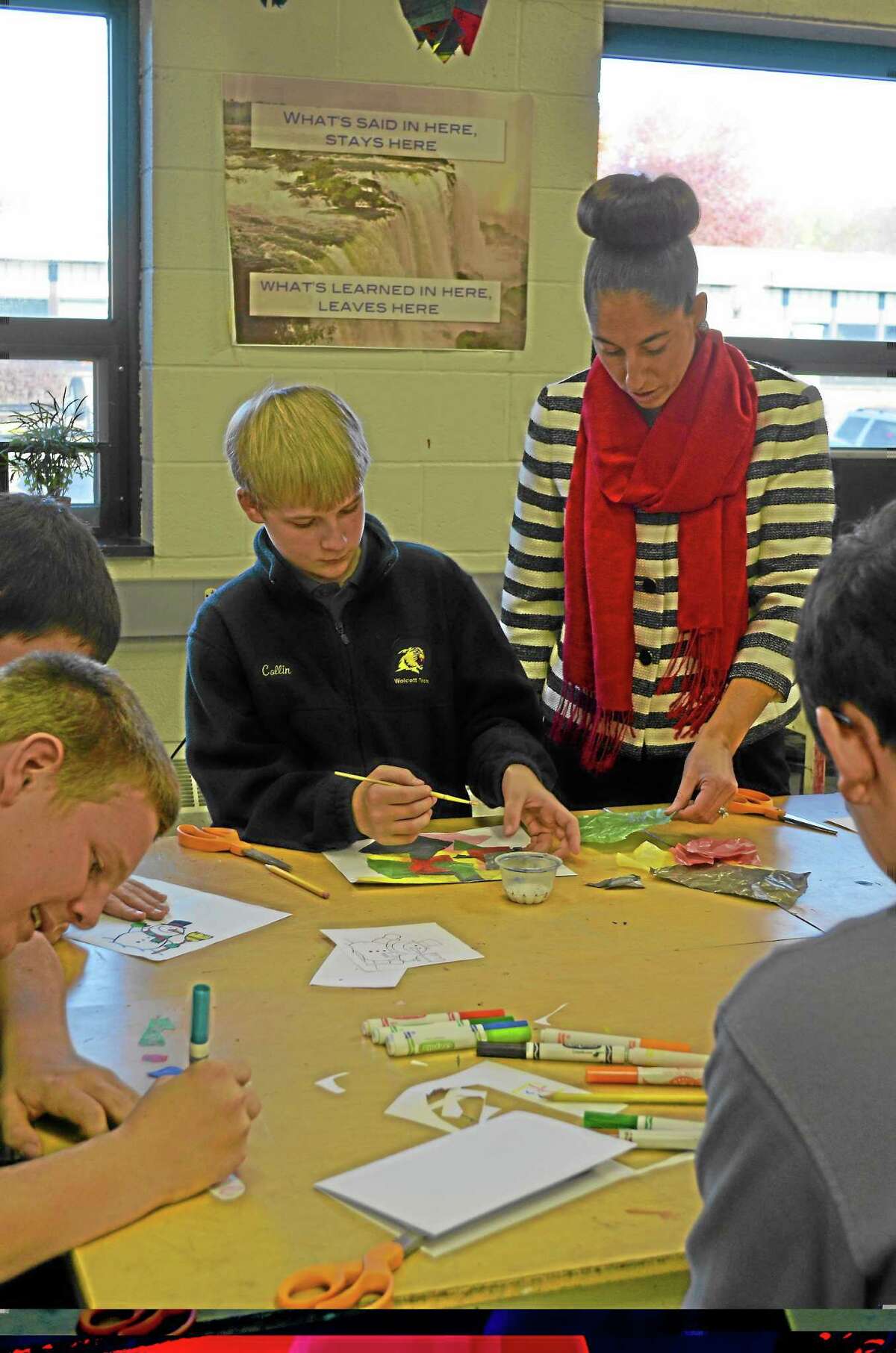 Morgan Slkovich-For the Register CitizenCollin Schultz, 14, freshman leadership student gets feedback on his holiday card from Assistant Principal Tanya Celadon.