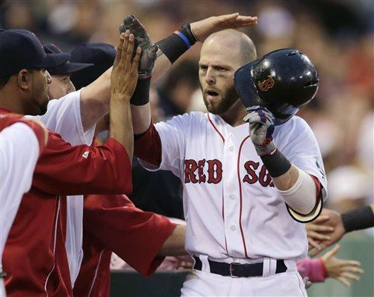Boston Red Sox's Dustin Pedroia is congratulated by teammates after his two-run home run off Toronto Blue Jays starting pitcher Chien-Ming Wang during the second inning of a baseball game at Fenway Park, Thursday, June 27, 2013, in Boston. (AP Photo/Charles Krupa)