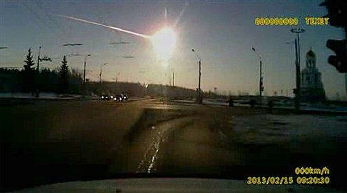 In this frame grab made from dashboard camera video, a meteor streaks through the sky over Chelyabinsk, about 1500 kilometers (930 miles) east of Moscow, Friday, Feb. 15, 2013. With a blinding flash and a booming shock wave, the meteor blazed across the western Siberian sky Friday and exploded with the force of 20 atomic bombs, injuring more than 1,000 people as it blasted out windows and spread panic in a city of 1 million. (AP Photo/AP Video)