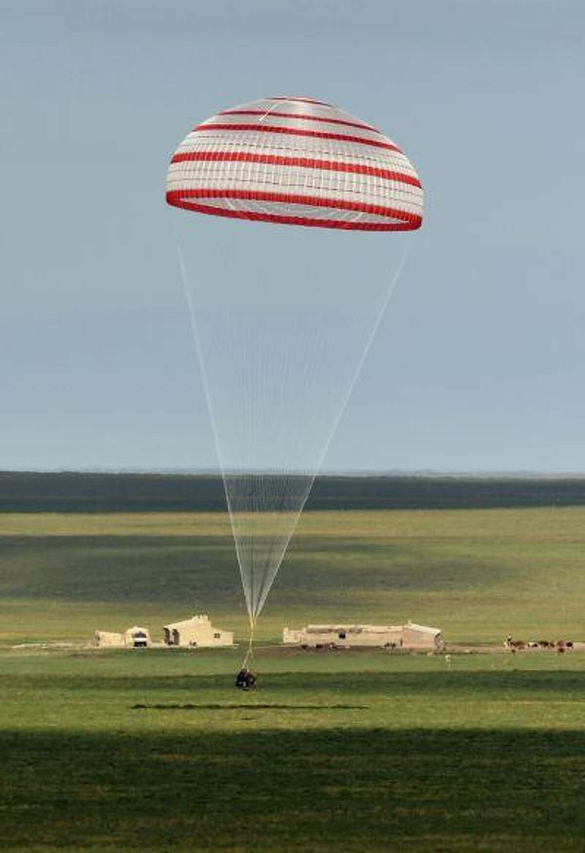 The re-entry capsule of China's Shenzhou-10 spacecraft lands at its main landing site in north China's Inner Mongolia Autonomous Region, June 26, 2013.