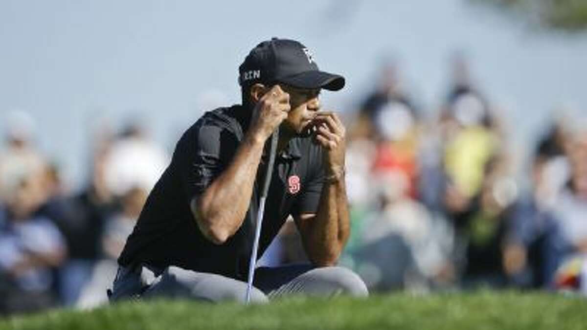 Tiger Woods waits his turn on the second green of the South Course at Torrey Pines during the third round of the Farmers Insurance Open Saturday in San Diego.