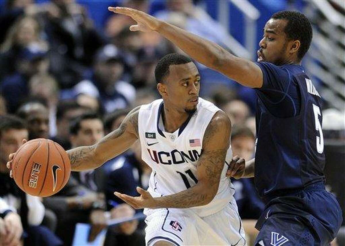 Connecticut's Ryan Boatright, left, is guarded by Villanova's Tony Chennault during the first half of an NCAA college basketball game in Hartford, Conn., Saturday, Feb. 16, 2013. (AP Photo/Fred Beckham)