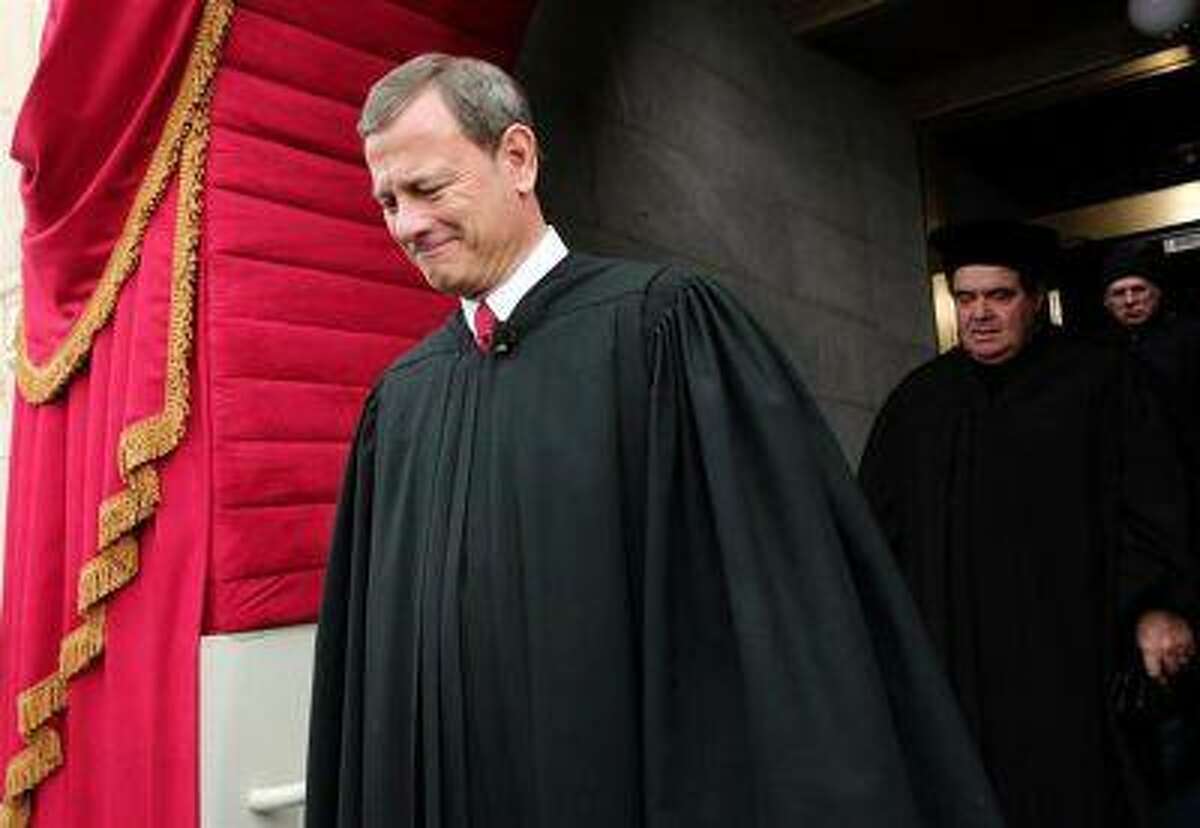 Supreme Court Chief Justice John Roberts is followed by Supreme Court Justice Antonin Scalia as they arrive for the presidential inauguration on the West Front of the U.S. Capitol in Washington January 21, 2013. (Win McNamee/Reuters/Pool)