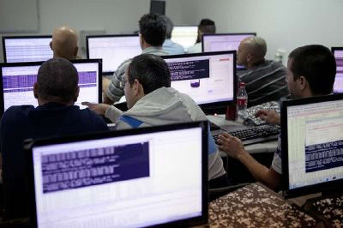 In this Tuesday Oct. 20, 2013 photo, Israelis work on computers at the 'CyberGym' school in the coastal city of Hadera. When Israel's military chief delivered a high-profile speech this month outlining the greatest threats his country will face in the future, he listed computer sabotage as a top concern, warning a sophisticated cyber attack could one day bring the nation to a standstill.