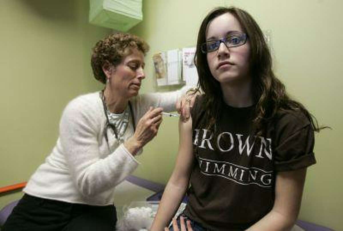 Nancy Brajtbord, RN, (L) administers a shot of gardasil, a Human Papillomavirus vaccine, to a 14-year old patient (who does not wish to be named) in Dallas. (Reuters/Jessica Rinaldi)
