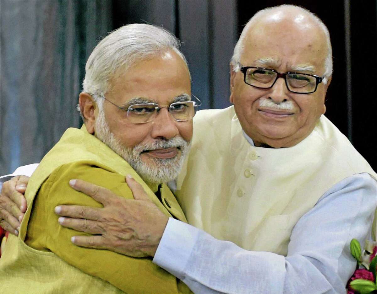 India's next prime minister and Hindu nationalist Bharatiya Janata Party (BJP) leader Narendra Modi, left, hugs party leader Lal Krishna Advani during the BJP parliamentary party meeting in New Delhi, India, Tuesday, May 20, 2014. Advani, the most senior party leader, nominated Modi for the prime minister's post, and the lawmakers gave their approval by thumping desks and raising slogans. (AP Photo)
